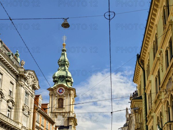 Historic architecture on a busy street with visible power lines Herz Jesu Kirche Graz Styria