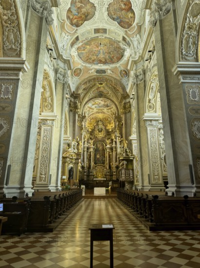 Magnificently decorated baroque interior with altar and ceiling frescoes, atmospheric play of