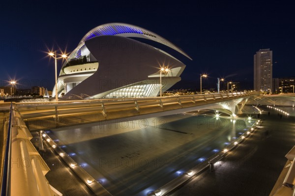 Valencia Spain Bright futuristic building and bridge illuminated at night in urban surroundings