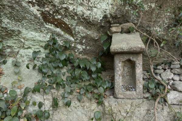 Small stone house for offerings with yen coins on the Shariki-michi Trail to Mount Nokogiri, Mount