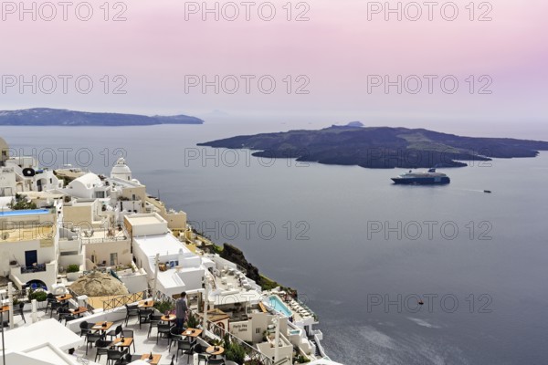 View from the island capital Fira to the uninhabited volcanic island Nea Kameni in the caldera,