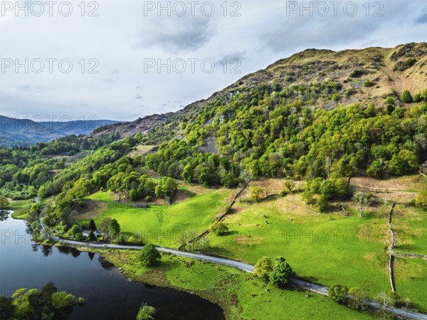 Farms and Mountains over road A591 from a drone, Grasmere Lake, Grasmere, Ambleside, Lake District,