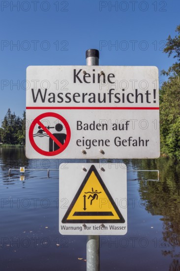 Warning sign, no water supervision, bathing at your own risk in the ArgenbÃ¼hl moor pool near