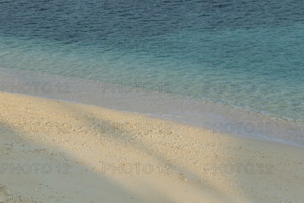 Sunlight, shade, sand and turquoise water at Sesoko-jima beach, Sesoko Island, Motobu, Kunigami