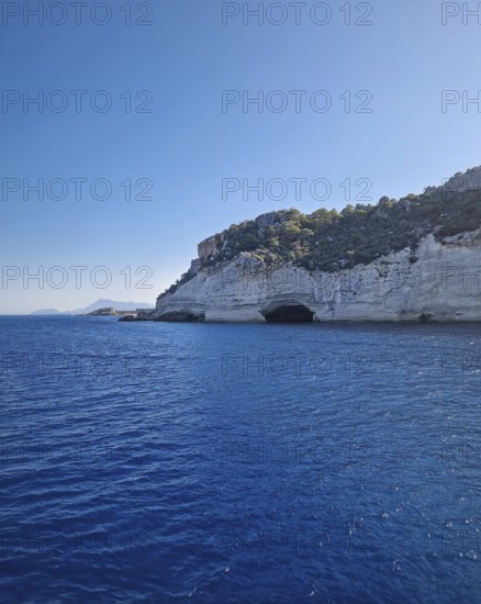 Vibrant seascape with the Pirate Cave in Kemer, Turkey. Beautiful Turkish mediterranean coastline