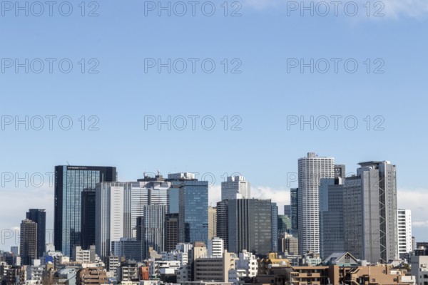 Modern architecture, view over the rooftops of the city to the glass facades of skyscrapers against