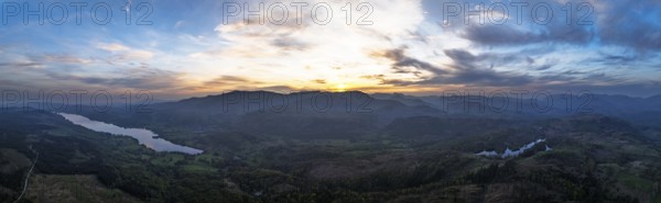 Panorama of Sunset over Mountains and Coniston Water from drone, Lake District National Park,