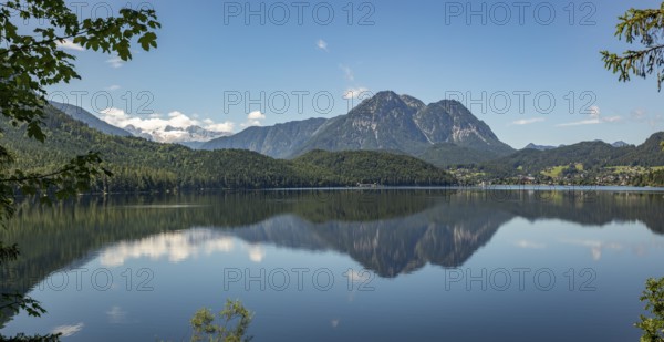 Peaceful lake surface with mountain panorama, Dachstein and Sarstein, cloud reflection in the