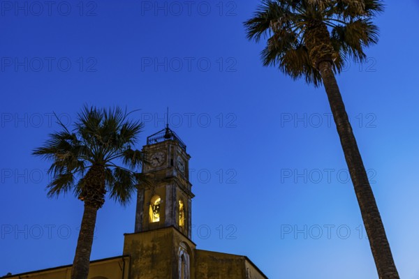 Illuminated steeple of the Madonna del Carmine church, night shot, Porto Azzurro, Elba Island,