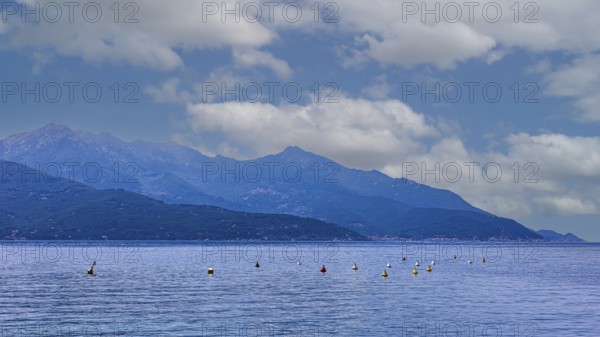 Clouds over the Golfo di Viticcio, in the background the mountains of Monte Capanne, Elba Island,