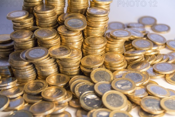Lots of stacked 1 euro coins