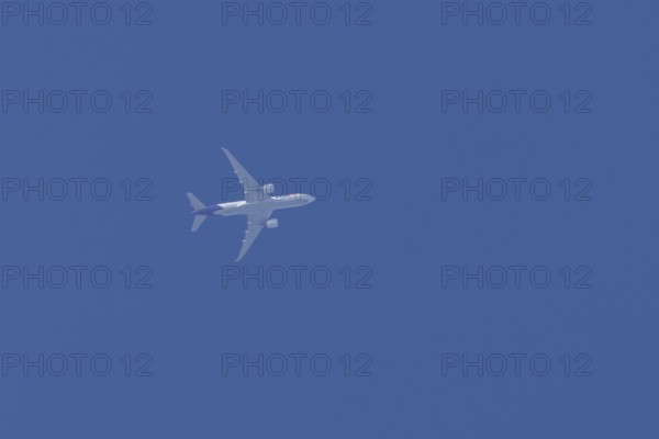 Airbus A300-600RF jet aircraft of FedEx Express airlines in flight in a blue sky, England, United