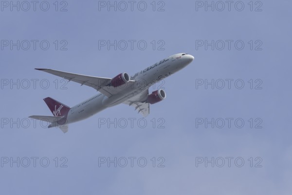 Boeing 787-9 Dreamliner jet passenger aircraft of Virgin Atlantic airlines in flight in a blue sky,