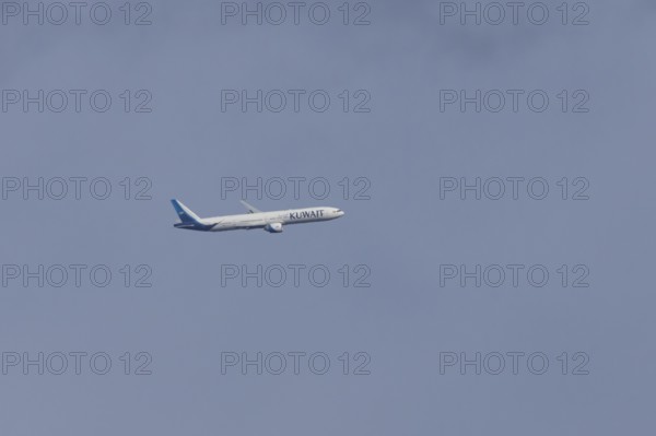 Boeing 777 jet passenger aircraft of Kuwait airlines in flight in a blue sky, England, United
