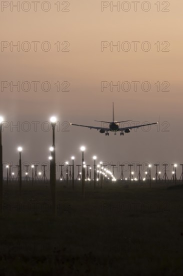 Boeing 737 jet aircraft of Ryanair airlines in flight landing at sunset at London Stansted airport,