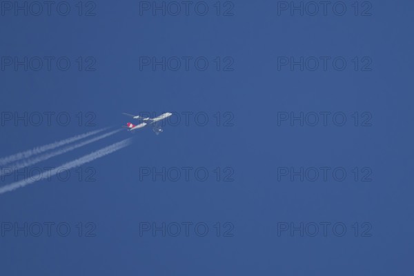 Boeing 747 Jumbo jet cargo aircraft of Cargolux airlines in flight in a blue sky with vapour trails