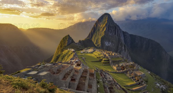 Dramatic landscape photo of Machu Picchu at sunrise, with the ancient Inca citadel illuminated by