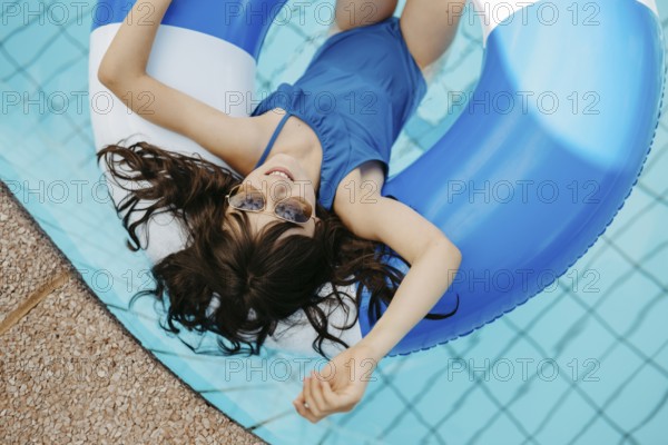 Girl, 10, swims in a swimming tyre in the pool