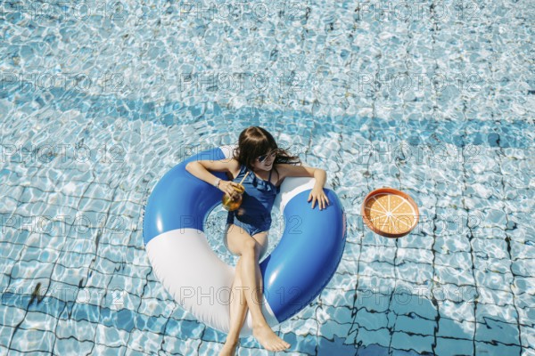 Girl, 10, swims in a swimming tyre in the pool