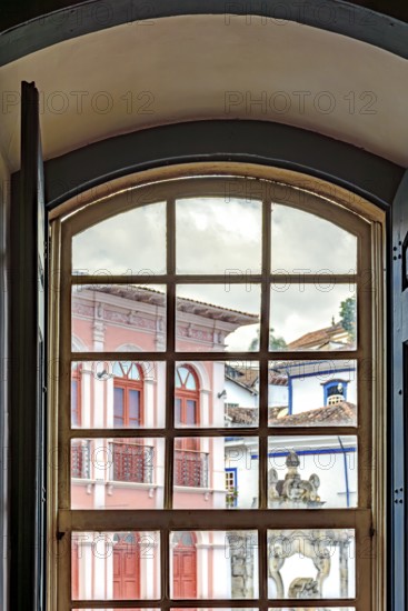 View of the city of Ouro Preto through an old window in a colonial mansion, Ouro Preto, Minas