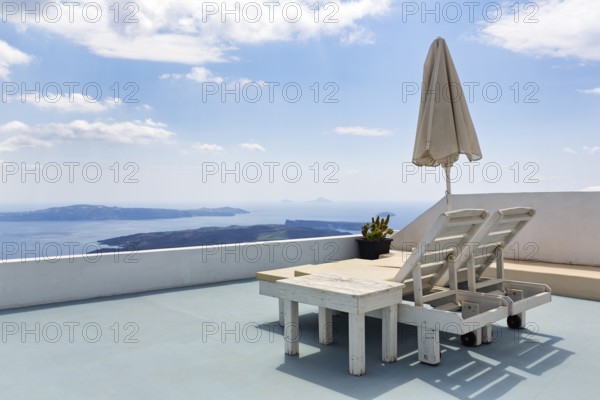 Two deckchairs on a sun terrace with sea view, Imerovigli, Thira, Santorini, Cyclades, Greece
