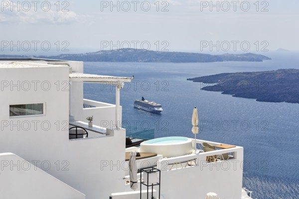 Characteristic white holiday homes with views of the caldera and the Aegean Sea, cruise ship,