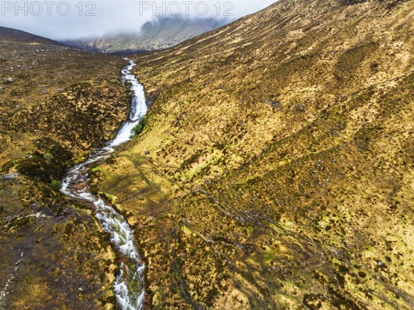 Eas a' Bhradain Waterfall from drone, Red Cuillin mountains, Loch Ainort, Isle of Skye, Scotland,