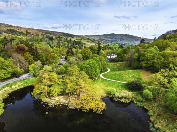 Farms and Mountains over road A591 from a drone, Grasmere Lake, Grasmere, Ambleside, Lake District,