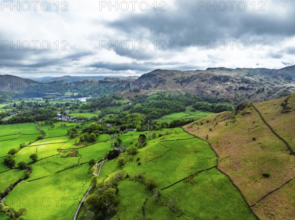 Farms and Mountains over road A591 from a drone, Grasmere Lake, Grasmere, Ambleside, Lake District,