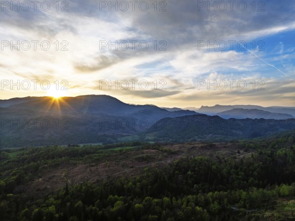 Sunset over Mountains and Coniston Water from drone, Lake District National Park, Cumbria, England,