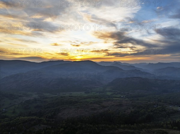 Sunset over Mountains and Coniston Water from drone, Lake District National Park, Cumbria, England,