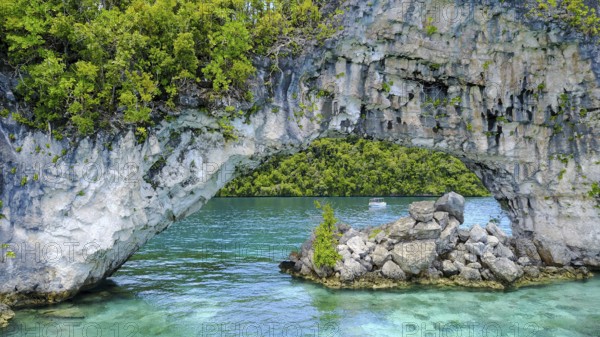 View through rock arch Natural Arch in lagoon of in island paradise island state Palau in the