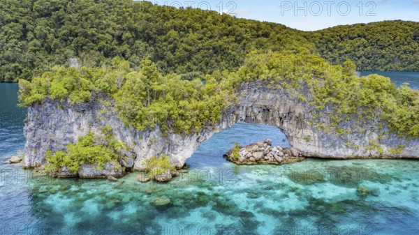 Aerial view bird's eye view through rock arch Natural Arch in lagoon of island paradise island
