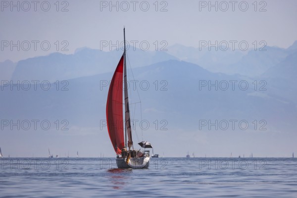 Sailing ship travelling on Lake Constance. The Swiss Alps in the background. Immenstaad,