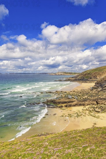 Rolling waves to the beach at a rocky coastline a beautiful sunny day by the sea, Crozon peninsula,