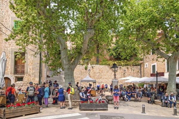 Many tourists in the square with outdoor restaurants in Fornalutx an old idyllic village in