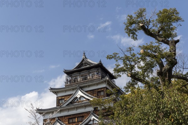 Hiroshima Castle, also known as Carp Castle, against a blue sky, replica of the original destroyed