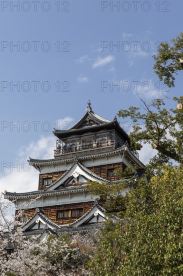 Hiroshima Castle, also known as Carp Castle, against a blue sky, replica of the original destroyed
