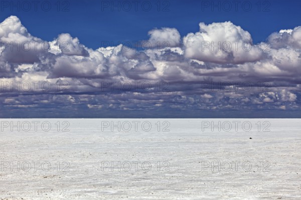 Cloudy sky over a flat salt landscape with a calm atmosphere, The endless expanses of the salt