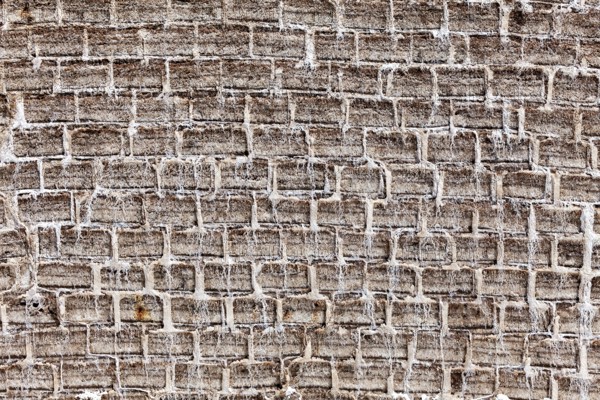 General view of a textured brick wall in earthy tones with an antique look, A wall made of salt