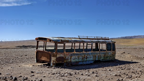 A rusty bus stands in a lonely desert landscape under a clear blue sky, An old Bus at the Border