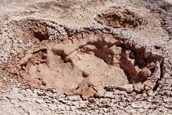 Large geothermal crater with dried mud and cracks, The mud volcanoes and fumaroles on the Altiplano