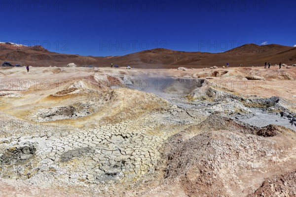 Vast geothermal landscape in a dry desert under a clear sky, The mud volcanoes and fumaroles on the