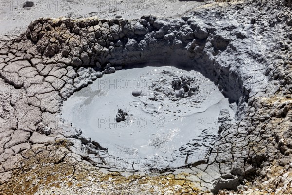 Small mud pool in eroded geothermal crater, The mud volcanoes and fumaroles on the Altiplano in