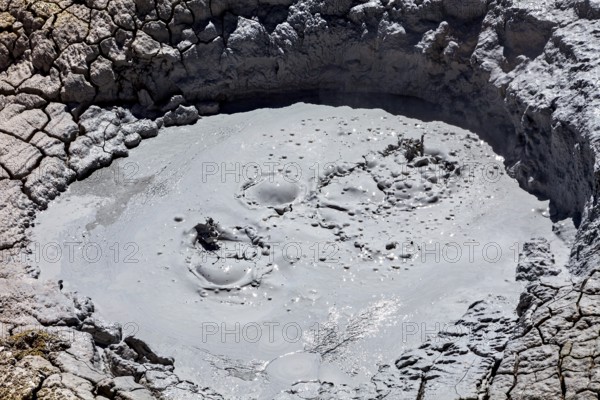 Close-up of a cracked crater covered with muddy bubbles, The mud volcanoes and fumaroles on the