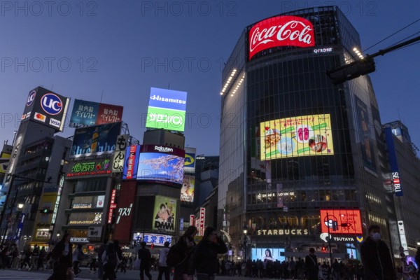 Crowd crossing the zebra crossings of Shibuya Crossing, world-famous intersection in Shibuya