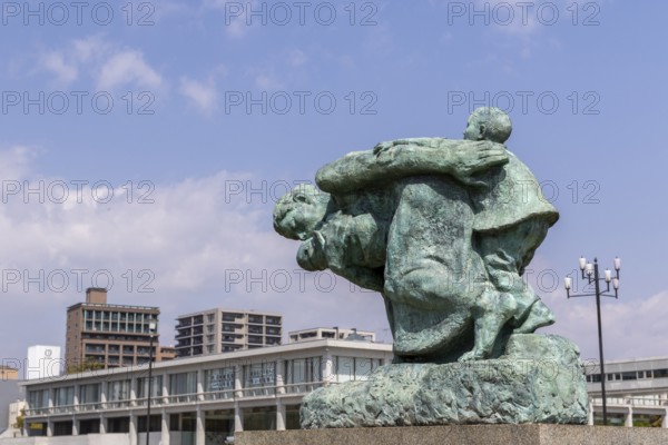 Statue of mother and children in the storm, bronze statue by the artist Shin Hongo in front of the