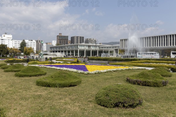 Colourful flower beds and fountains in front of the Hiroshima Peace Museum, tourist attraction,