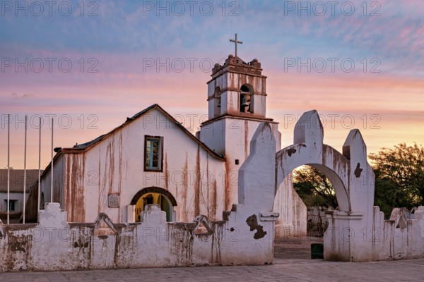 Church at sunset, warm colour palette with illuminated sky and cross tower, The church of San Pedro