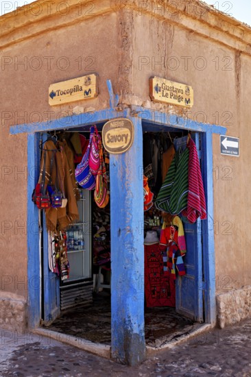 Corner of a souvenir shop with colourful textiles and handicrafts. Rustic style with striking blue